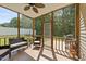 Inviting screened porch with comfortable seating, ceiling fan, and view of the backyard at 609 Woodson Dr, Clayton, NC 27527