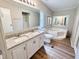 Bathroom features a soaking tub, double sink vanity with white cabinets, and wood-look flooring at 6579 Sidney Cottrell Rd, Oxford, NC 27565