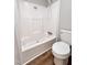 Bathroom featuring a shower-tub combo and a white toilet at 6579 Sidney Cottrell Rd, Oxford, NC 27565