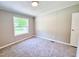 Bedroom with a window letting in lots of natural light and plush carpeting at 6579 Sidney Cottrell Rd, Oxford, NC 27565