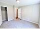 Carpeted bedroom featuring a closet and doorway at 6579 Sidney Cottrell Rd, Oxford, NC 27565