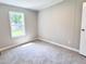 Carpeted bedroom with a window showing lush exterior landscaping at 6579 Sidney Cottrell Rd, Oxford, NC 27565