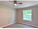 Neutral bedroom featuring a ceiling fan, window, and neutral carpeting at 6579 Sidney Cottrell Rd, Oxford, NC 27565