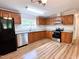 Updated kitchen features granite countertops, stainless steel appliances, and wood cabinets at 6579 Sidney Cottrell Rd, Oxford, NC 27565