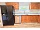 The kitchen includes stainless steel appliances, wood cabinets, granite countertops, and new flooring at 6579 Sidney Cottrell Rd, Oxford, NC 27565