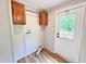 Laundry room with overhead storage cabinets and a white exterior door at 6579 Sidney Cottrell Rd, Oxford, NC 27565