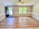 Cozy living room featuring new flooring, ample natural light, and a welcoming entry door at 6579 Sidney Cottrell Rd, Oxford, NC 27565