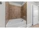 Modern bathroom with a tiled shower and bathtub combination at 700 Finsbury St # 105, Durham, NC 27703