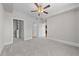 Spacious carpeted bedroom with ample natural light, an open doorway and a walk-in closet at 700 Finsbury St # 105, Durham, NC 27703