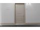 Apartment 105's entrance features a neutral-toned door in a well-lit hallway at 700 Finsbury St # 105, Durham, NC 27703