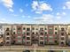 Apartment complex with brick facade, multiple balconies, and beautifully landscaped grounds at 700 Finsbury St # 105, Durham, NC 27703
