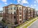 Attractive brick apartment building featuring balconies, light-colored accents, and well-maintained landscaping at 700 Finsbury St # 105, Durham, NC 27703