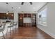View of the empty living area with built-in shelves, hardwood floors, and a window at 700 Finsbury St # 105, Durham, NC 27703