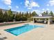 Community pool with inviting blue water and a poolside structure for relaxing at 700 Finsbury St # 105, Durham, NC 27703