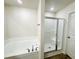 Modern bathroom with soaking tub, a separate shower, and neutral finishes at 71 Earnest Way, Kenly, NC 27542