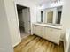 Bathroom featuring dual sinks, granite countertops, and walk-in closet access at 71 Earnest Way, Kenly, NC 27542