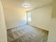 Cozy bedroom with plush carpeting, a neutral color palette, and natural light from a window at 71 Earnest Way, Kenly, NC 27542