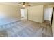 Inviting bedroom showcasing neutral carpet, ceiling fan, and access to bathroom at 71 Earnest Way, Kenly, NC 27542