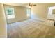 Sunlit bedroom with neutral carpet, ceiling fan, and serene window views at 71 Earnest Way, Kenly, NC 27542