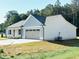 Side view of a home with a two-car garage, showcasing its well-maintained exterior at 71 Earnest Way, Kenly, NC 27542