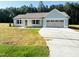 Charming single-story home featuring a two-car garage and inviting front yard at 71 Earnest Way, Kenly, NC 27542