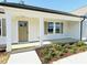 Close-up of a home entrance with a covered porch and manicured landscaping at 71 Earnest Way, Kenly, NC 27542