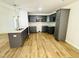 Modern kitchen featuring dark cabinets, granite countertops, and stainless steel appliances at 71 Earnest Way, Kenly, NC 27542