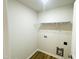 Functional laundry room with white walls, shelving and utility connections at 71 Earnest Way, Kenly, NC 27542