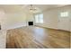 Open living room featuring a fireplace, vaulted ceilings and wood-look flooring at 71 Earnest Way, Kenly, NC 27542