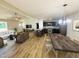 Open-concept living room, dining area, and kitchen with modern finishes, hardwood floors, and lots of natural light at 71 Earnest Way, Kenly, NC 27542