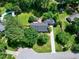Stunning aerial view of a home with a brick patio, manicured landscaping, and mature trees at 7204 Bellweather N Ct, Raleigh, NC 27615