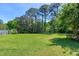 Lush, green backyard with mature trees provides a peaceful and private outdoor retreat at 7204 Bellweather N Ct, Raleigh, NC 27615