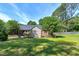 Expansive backyard features a well-maintained lawn, mature trees, and a charming picket fence at 7204 Bellweather N Ct, Raleigh, NC 27615