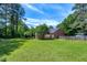 Well-maintained lawn with mature trees and shrubbery provide a private backyard setting at 7204 Bellweather N Ct, Raleigh, NC 27615