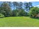 Large, well-manicured lawn with mature trees create a private and inviting backyard space at 7204 Bellweather N Ct, Raleigh, NC 27615