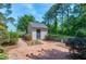 A brick patio with a shed in a private fenced yard surrounded by trees at 7204 Bellweather N Ct, Raleigh, NC 27615