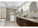 Primary bathroom featuring a soaking tub, walk-in shower, double sink vanity and modern lighting at 7204 Bellweather N Ct, Raleigh, NC 27615