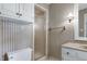 A well-lit bathroom showcasing a shower, commode, and storage cabinets at 7204 Bellweather N Ct, Raleigh, NC 27615