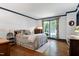 A charming bedroom features hardwood floors, a large window and crown molding at 7204 Bellweather N Ct, Raleigh, NC 27615