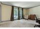 A well-lit bedroom with large windows, carpet and neutral colored walls at 7204 Bellweather N Ct, Raleigh, NC 27615