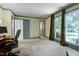 An expansive bedroom featuring carpeting, natural light, and multiple doors at 7204 Bellweather N Ct, Raleigh, NC 27615