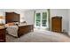 A bright bedroom featuring carpet, natural light, and classic furniture at 7204 Bellweather N Ct, Raleigh, NC 27615