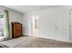 Bright bedroom boasts a window, antique dresser, and an ensuite bathroom featuring a soaking tub at 7204 Bellweather N Ct, Raleigh, NC 27615