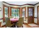 Sun-drenched breakfast nook with hardwood floors, large windows, and classic trim, perfect for morning coffee at 7204 Bellweather N Ct, Raleigh, NC 27615