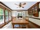 Well-lit dining room with hardwood floors, large windows, and decorative ceiling fan is perfect for entertaining at 7204 Bellweather N Ct, Raleigh, NC 27615