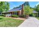 Brick home with driveway leading to a covered carport at 7204 Bellweather N Ct, Raleigh, NC 27615