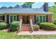 Brick home with manicured landscaping, front entrance, and shutters at 7204 Bellweather N Ct, Raleigh, NC 27615