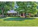 Well-maintained brick home with a beautiful front yard and mature trees at 7204 Bellweather N Ct, Raleigh, NC 27615
