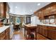 Spacious kitchen featuring wood cabinets, hardwood floors, and an adjacent breakfast nook, great for casual dining at 7204 Bellweather N Ct, Raleigh, NC 27615