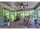 Relaxing screened porch features brick floors, rocking chairs, porch swing and ceiling fan at 7204 Bellweather N Ct, Raleigh, NC 27615